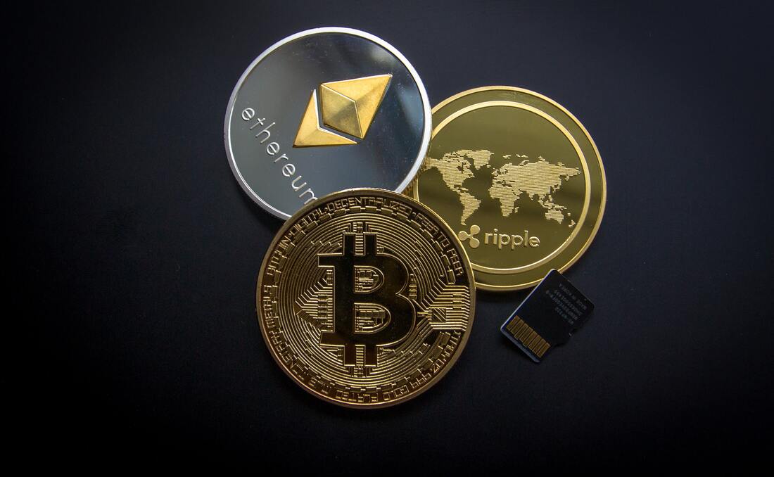 Different kinds of cryptocurrency visualized against a grey background.