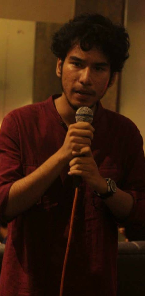Ekalavya Chaudhuri stands at a poetry reading.